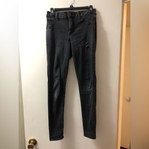 Size 6 black used skinny jeans with a couple of holes.